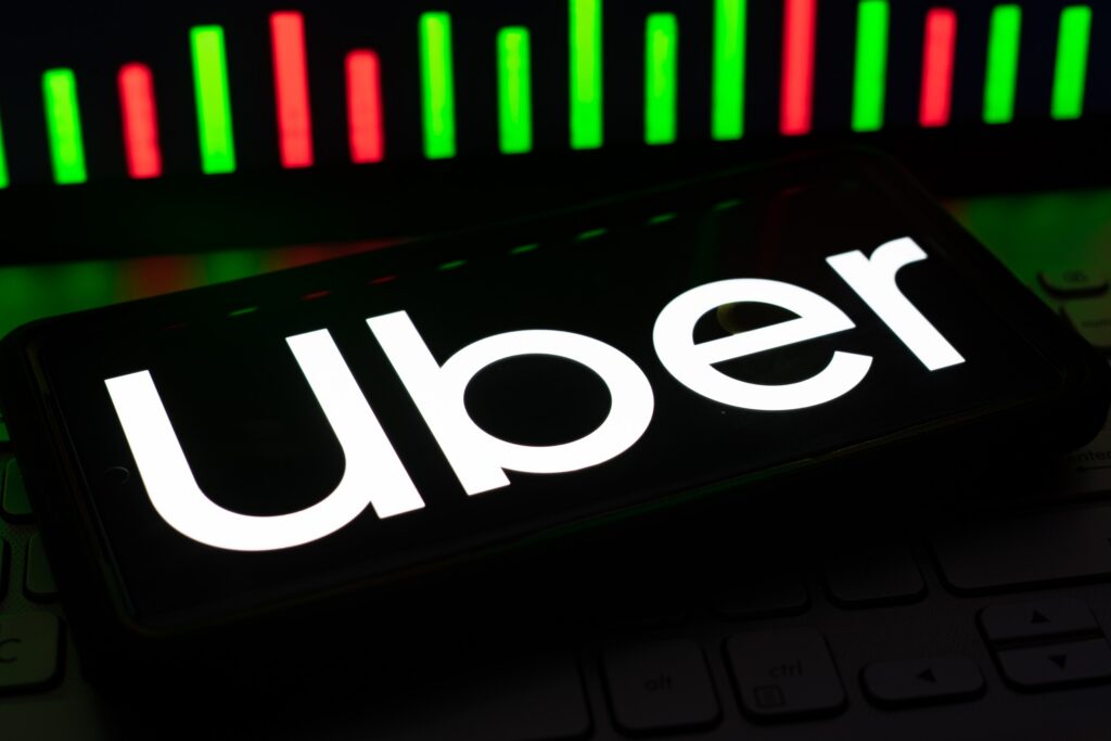 A smartphone displaying the white Uber logo representing Uber and Lyft Driver and Vehicle Requirements in Florida.