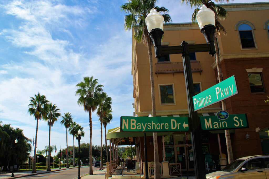 A downtown street sign at Main Street and Bayshore Drive highlights local areas tracked in Safety Harbor Car Accident Statistics.