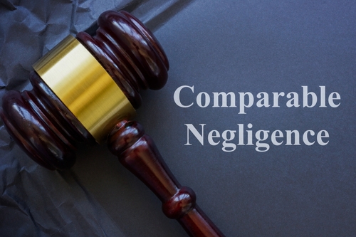 Judge’s gavel with the words “Comparable Negligence” written beside it.