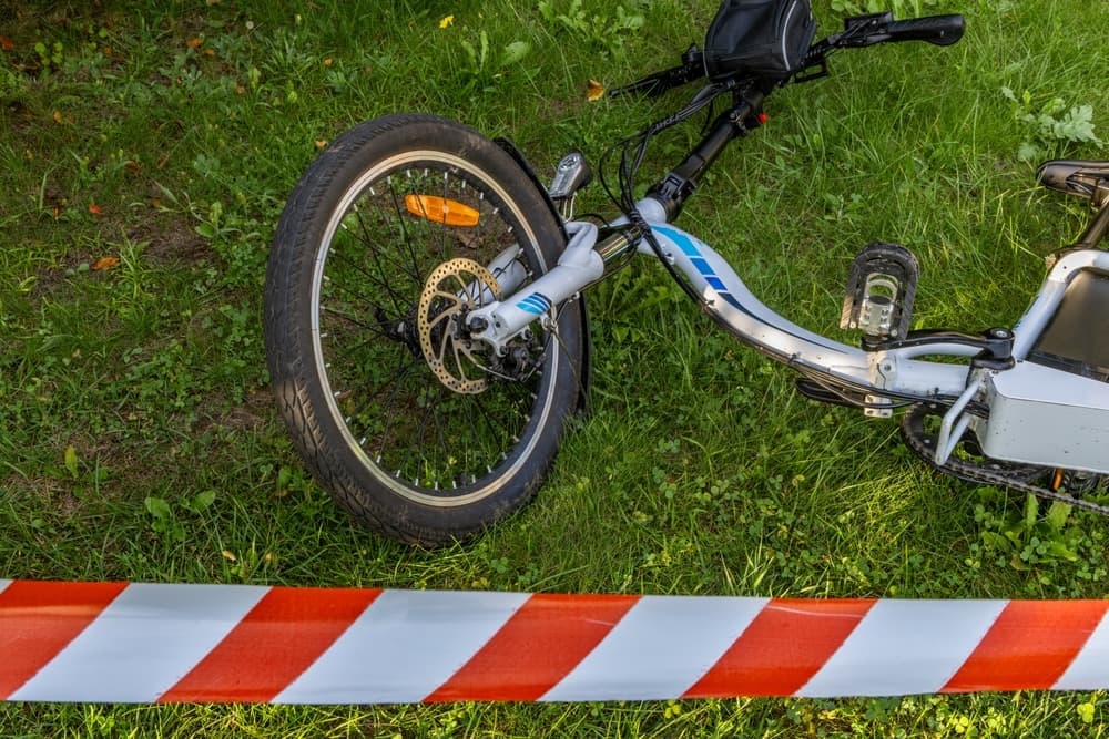 An accident on an electric bicycle, the area secured by the police with red and white protective tape