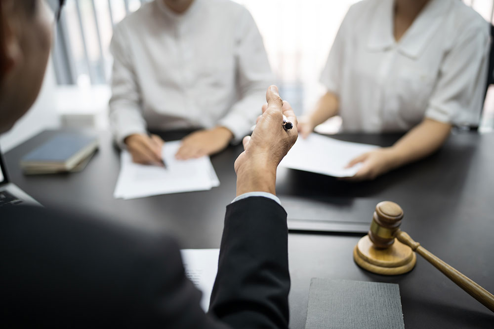Lawyer presenting a signed document with a gavel representing legal action and accountability for assisted living abuse
