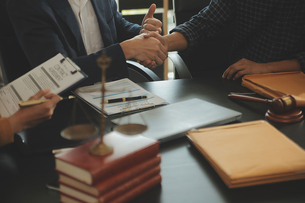 Attorney presenting a signed legal document with a gavel on the desk