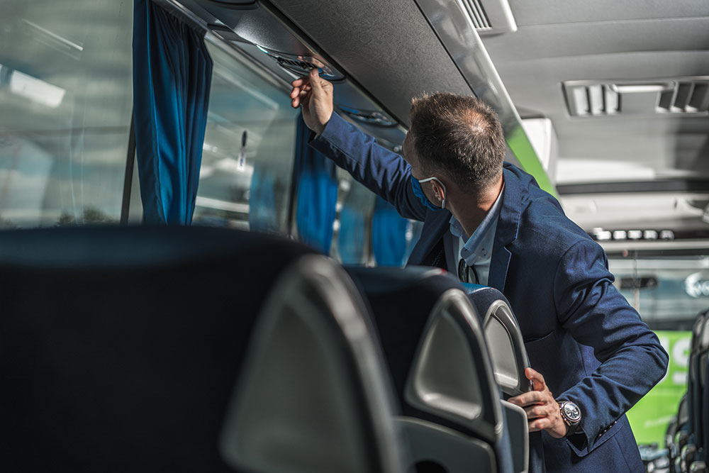 Shuttle driver inspecting the bus air-conditioning system