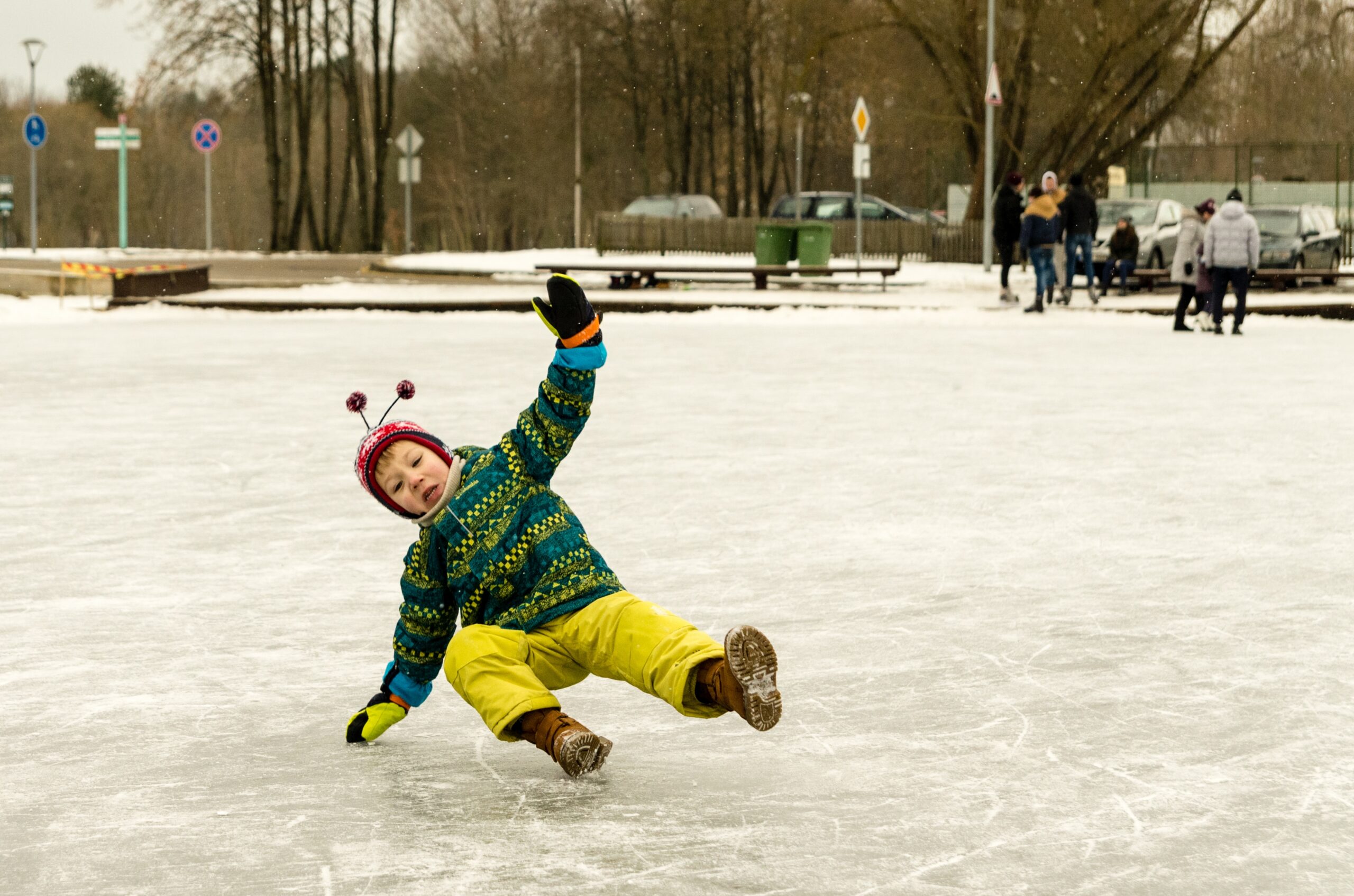 Child slipping and falling on ice representing slip and fall injury risks at sporting venues in Tampa