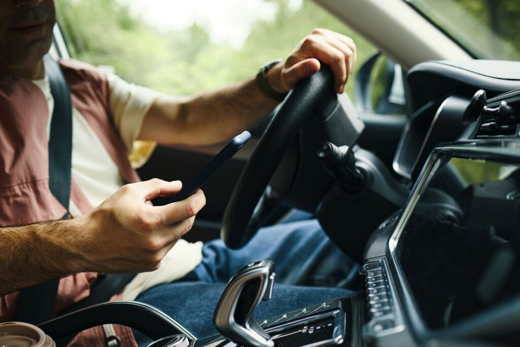 Driver texting behind the wheel in Clearwater, a common cause of crashes addressed by a Clearwater distracted driving accident lawyer