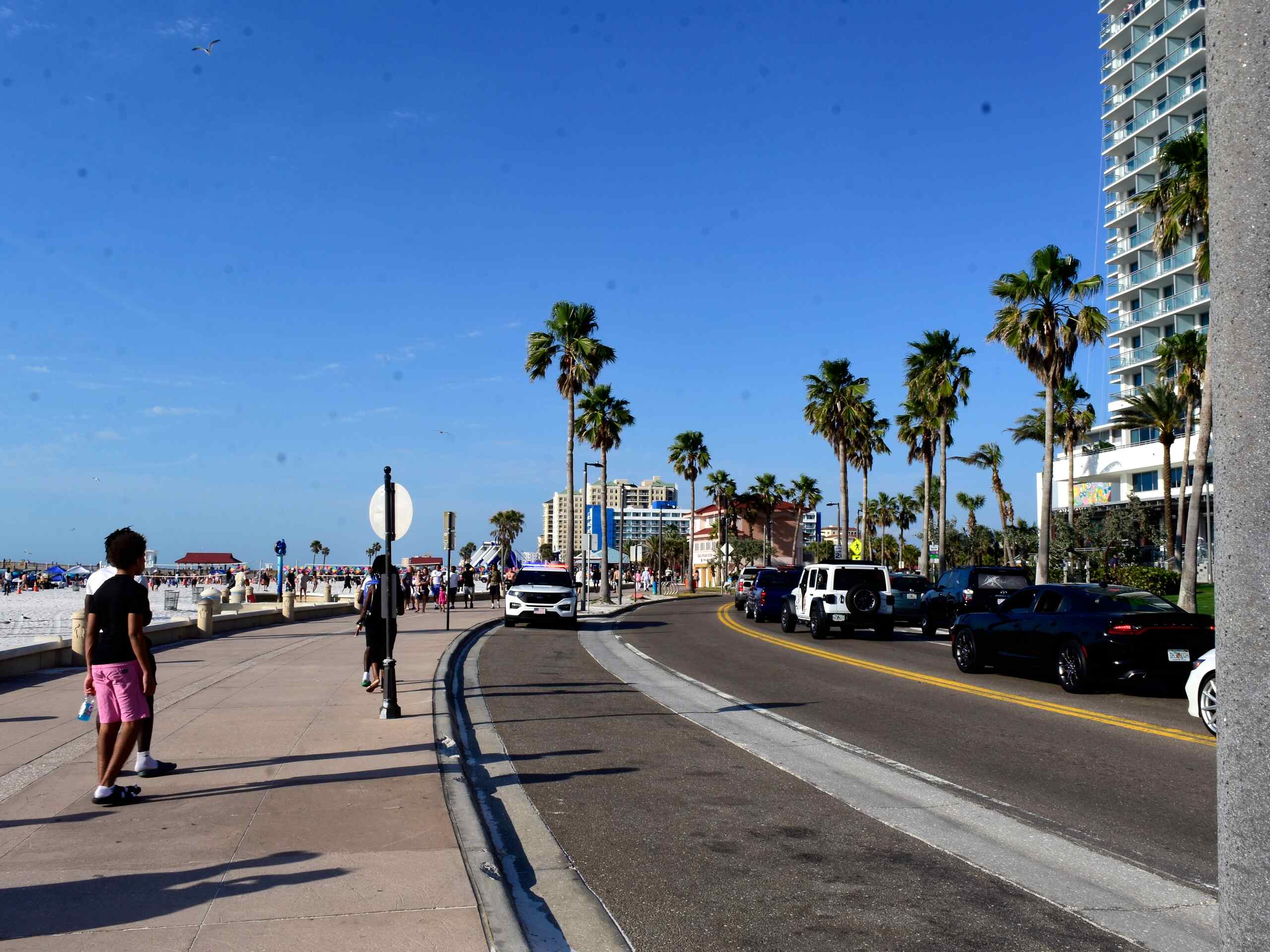 Busy Clearwater Beach road showing pedestrian traffic and vehicles under Florida pedestrian right-of-way laws