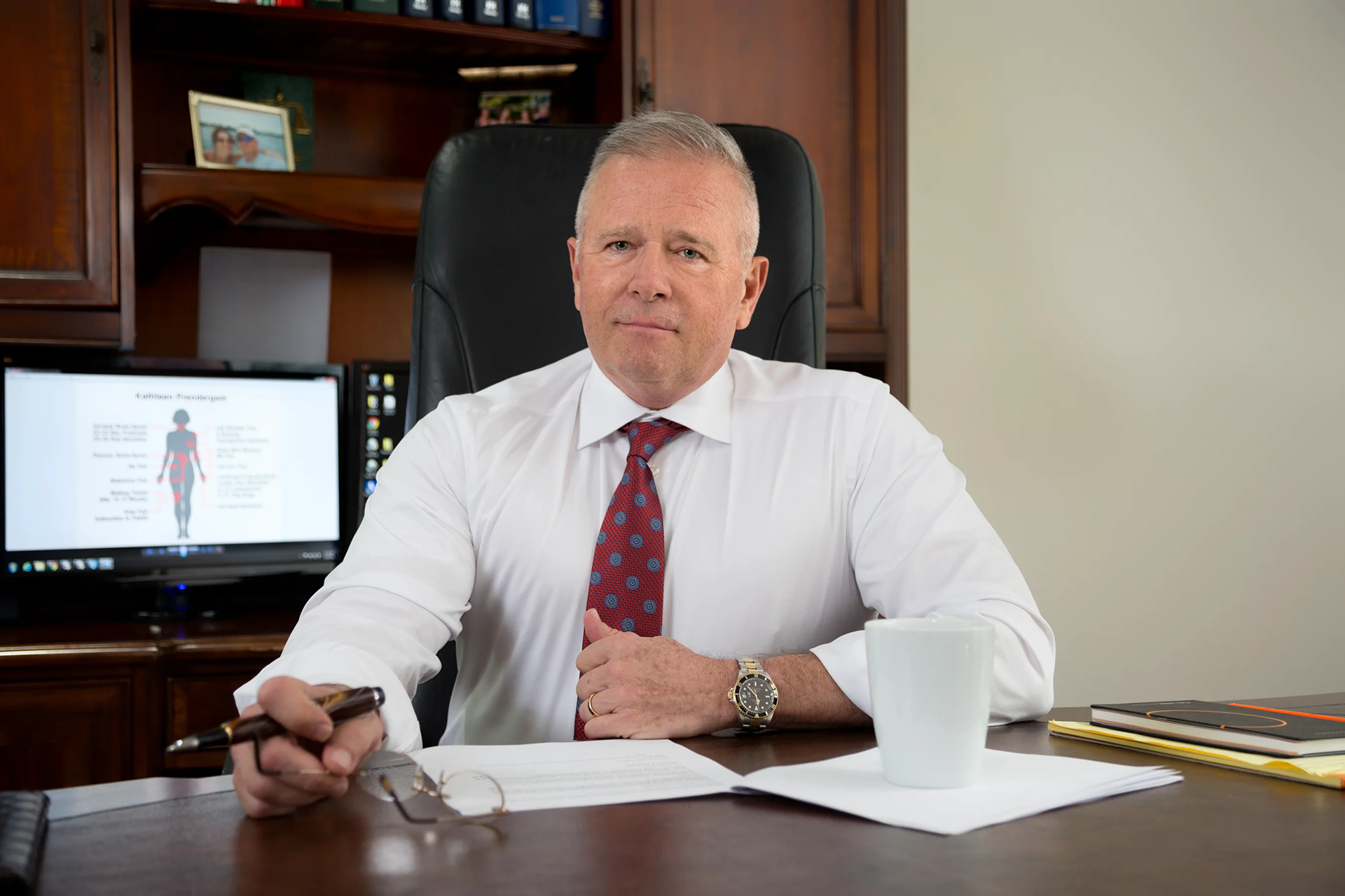 Attorney Mark Roman sitting at desk in office