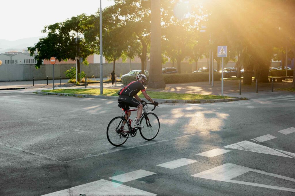 Cyclist riding through a road intersection while cycling on McMullen Booth Road in Safety Harbor.