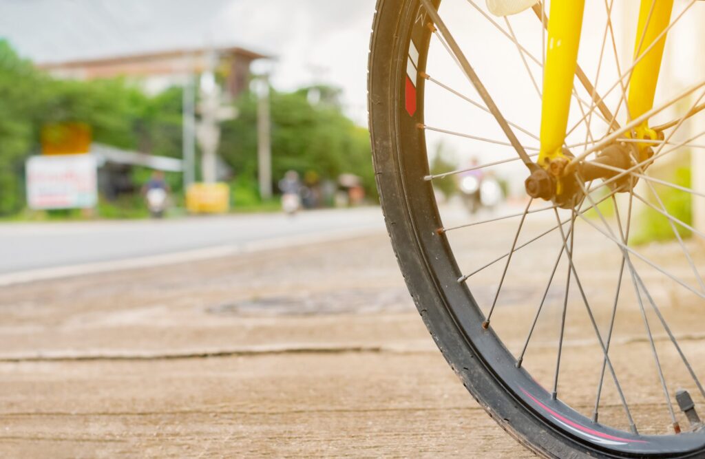 Close-up of a bicycle front wheel along the shoulder while cycling on McMullen Booth Road in Safety Harbor.