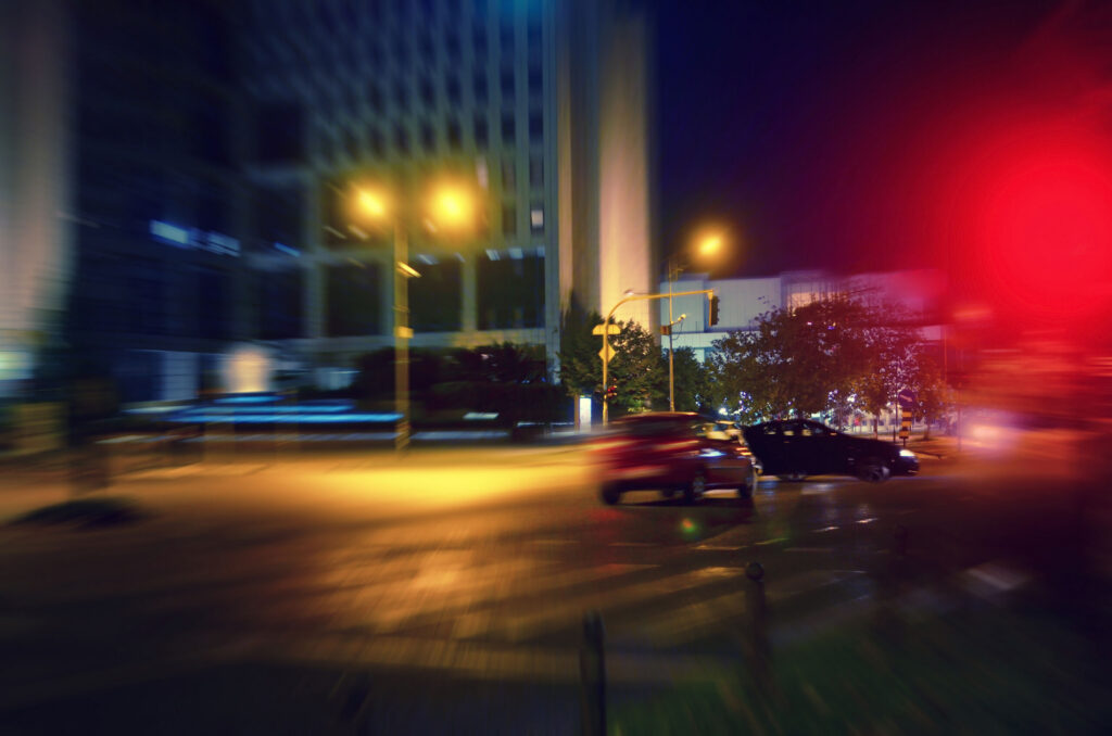 Motion blur of cars driving at night representing Safety Harbor hit-and-run accidents.