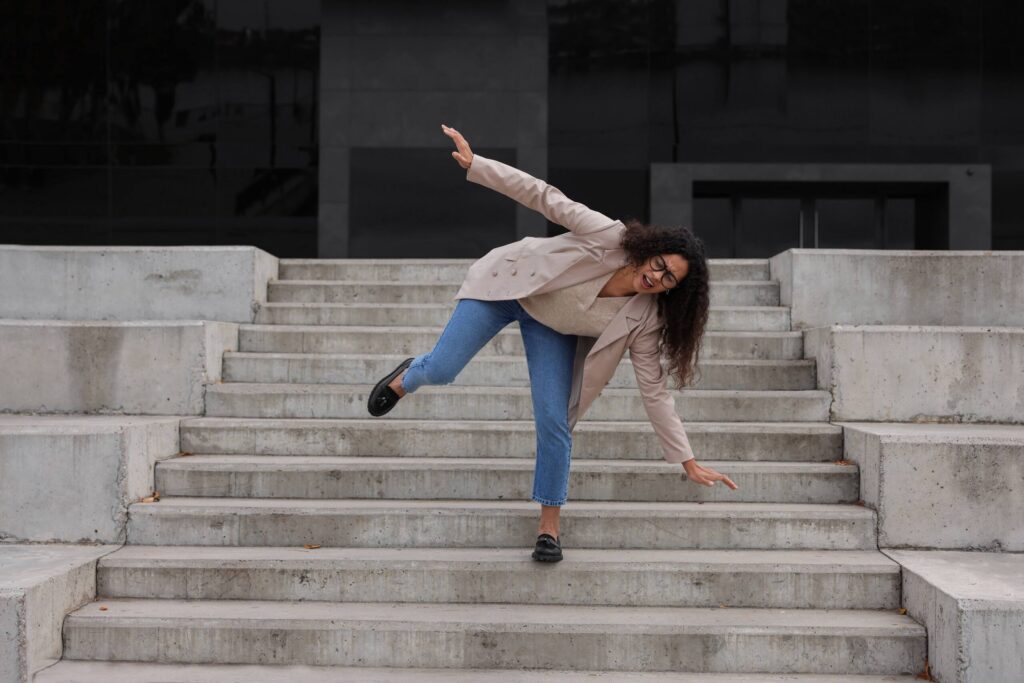 Woman losing balance on concrete stairs, related to Florida Slip & Fall Laws: Constructive Knowledge.