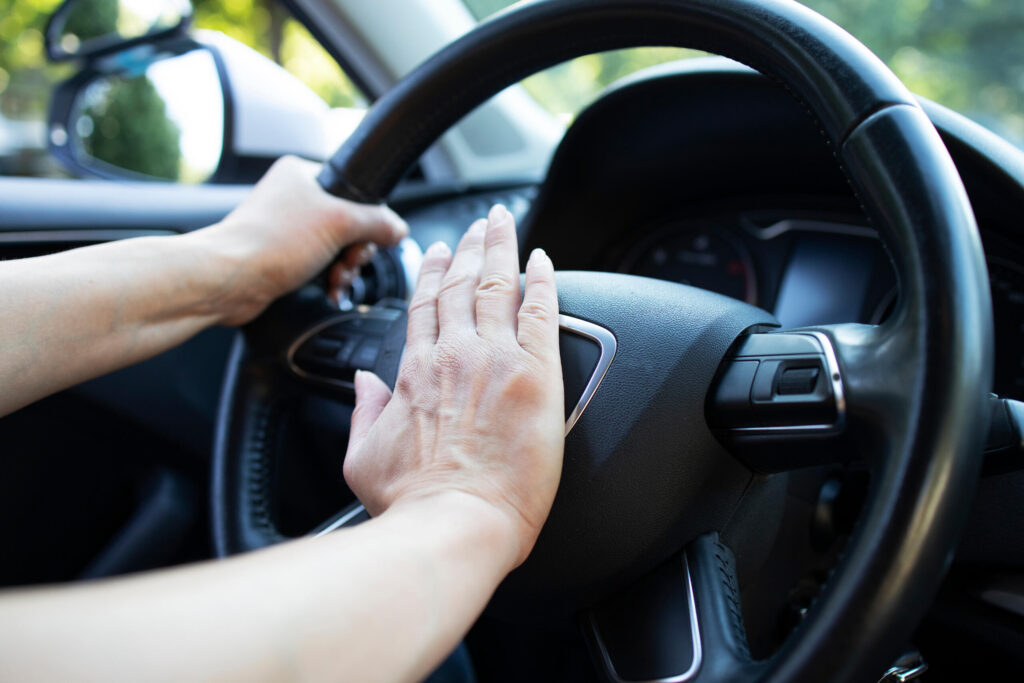 A driver pressing the car horn shows aggressive driving and road rage accidents in Safety Harbor.