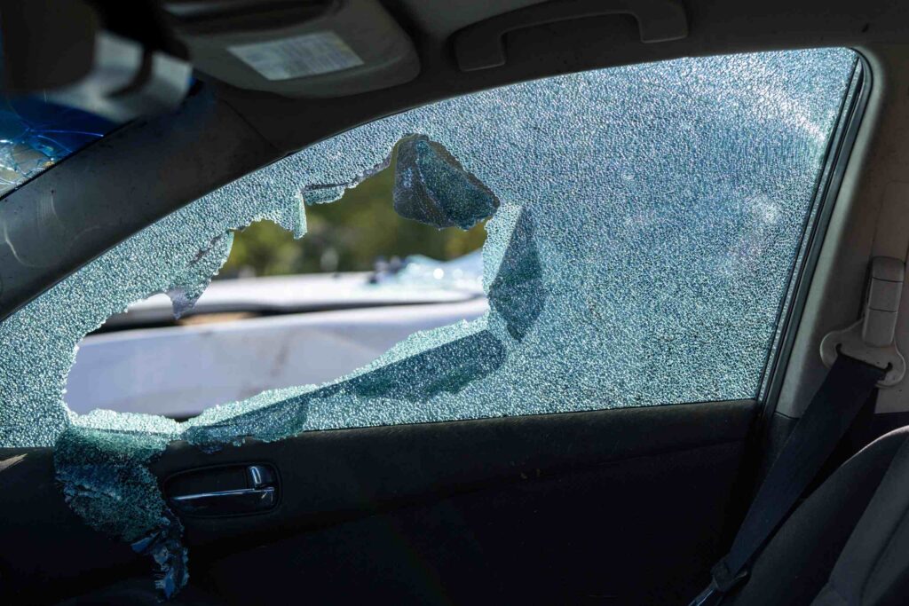 A shattered car window illustrates severe vehicle damage involved in a Safety Harbor Hit-and-Run: UM Coverage case.