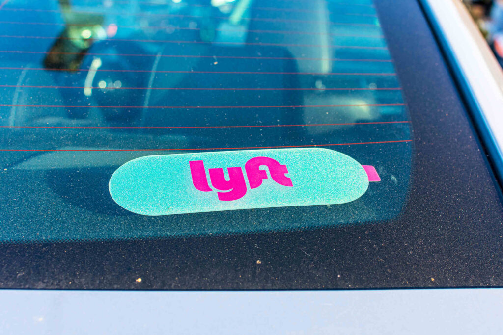 A Lyft decal on a car windshield represents rideshare injury cases handled by St Petersburg Lyft Accident Lawyers.