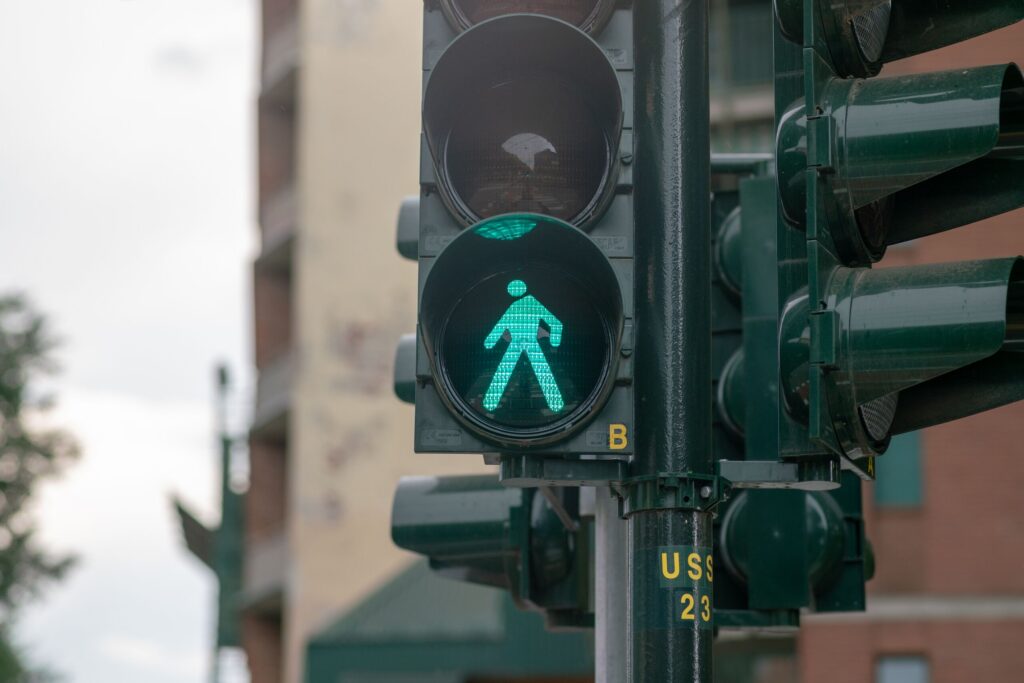 A green walk signal on a city traffic light represents pedestrian right of way cases handled by St Petersburg Pedestrian Accident Lawyers.