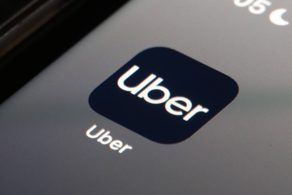 The Uber smartphone app screen highlights trip records to save when considering what to preserve after an Uber accident in Safety Harbor.