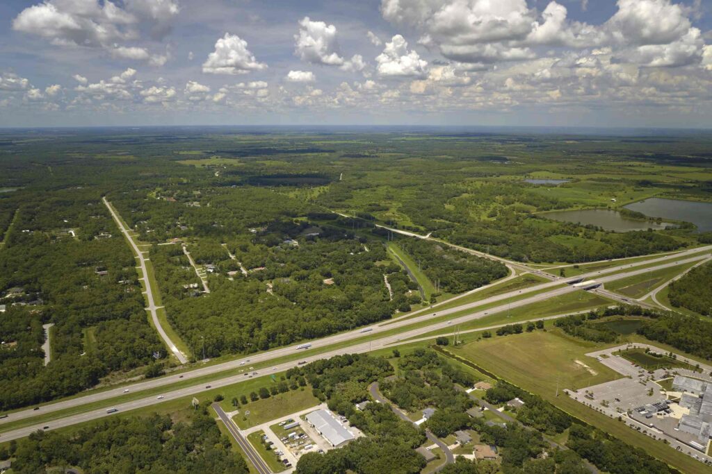 Aerial top down view of a major highway passing through local area explaining New Port Richey Commercial Truck Routes Liability in US 19 Crashes.