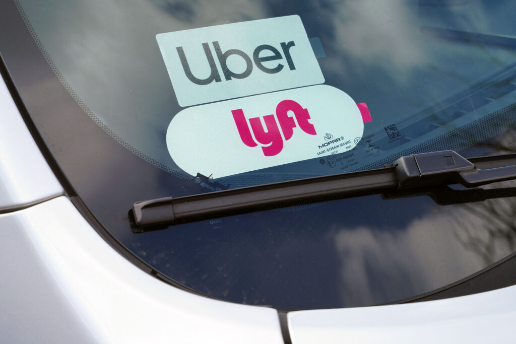 Uber and Lyft decals displayed on a car windshield served by Tampa Uber & Lyft Accident Lawyers.