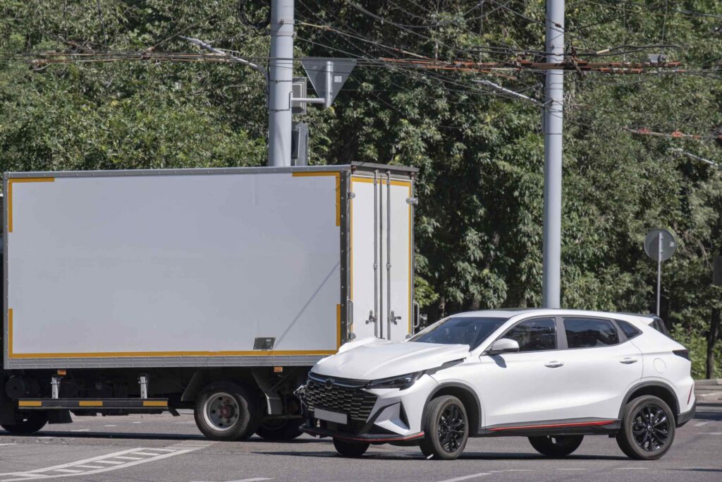 A white SUV with front end damage next to a delivery truck showing the most dangerous intersections for car accidents in New Port Richey.