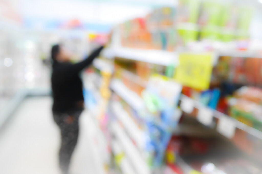 A blurred shopper reaching for high shelves in an aisle during a Slip and Fall at a Grocery Store in Clearwater.