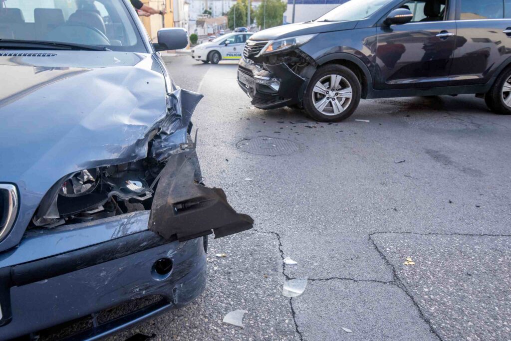 Two damaged cars at a road intersection investigated by professional Tampa Car Accident Lawyers.