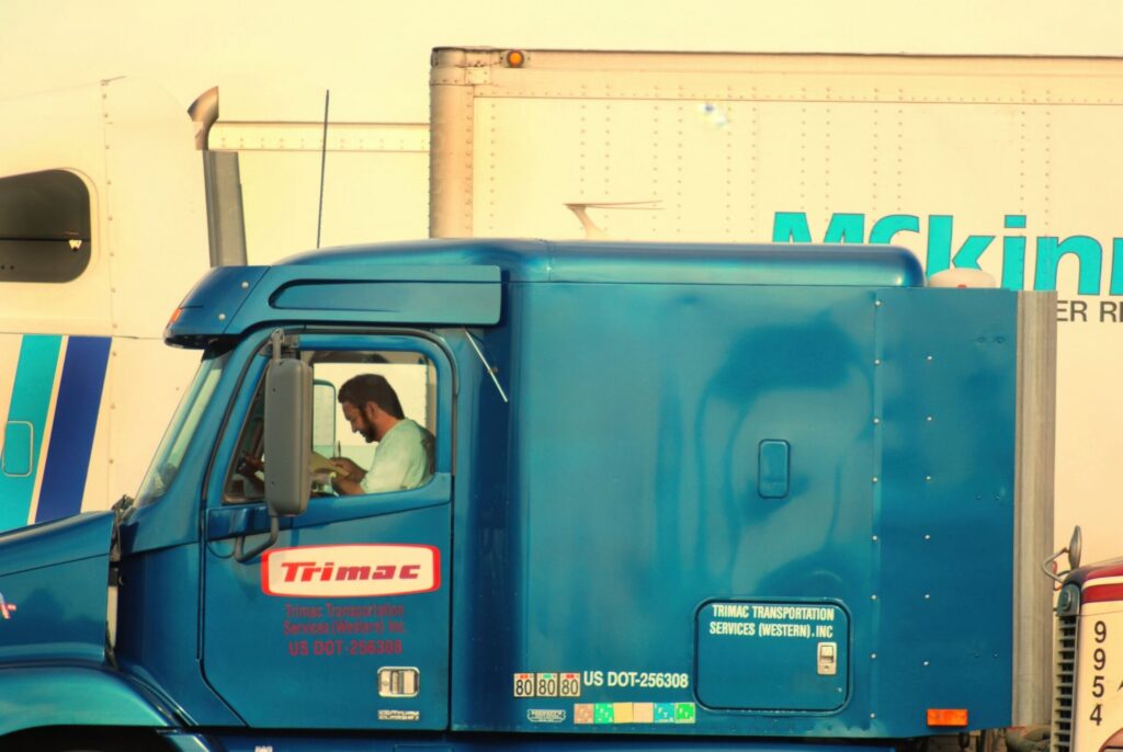 A semi truck driver reviewing logbooks in the cab before US 19 truck crashes in New Port Richey.