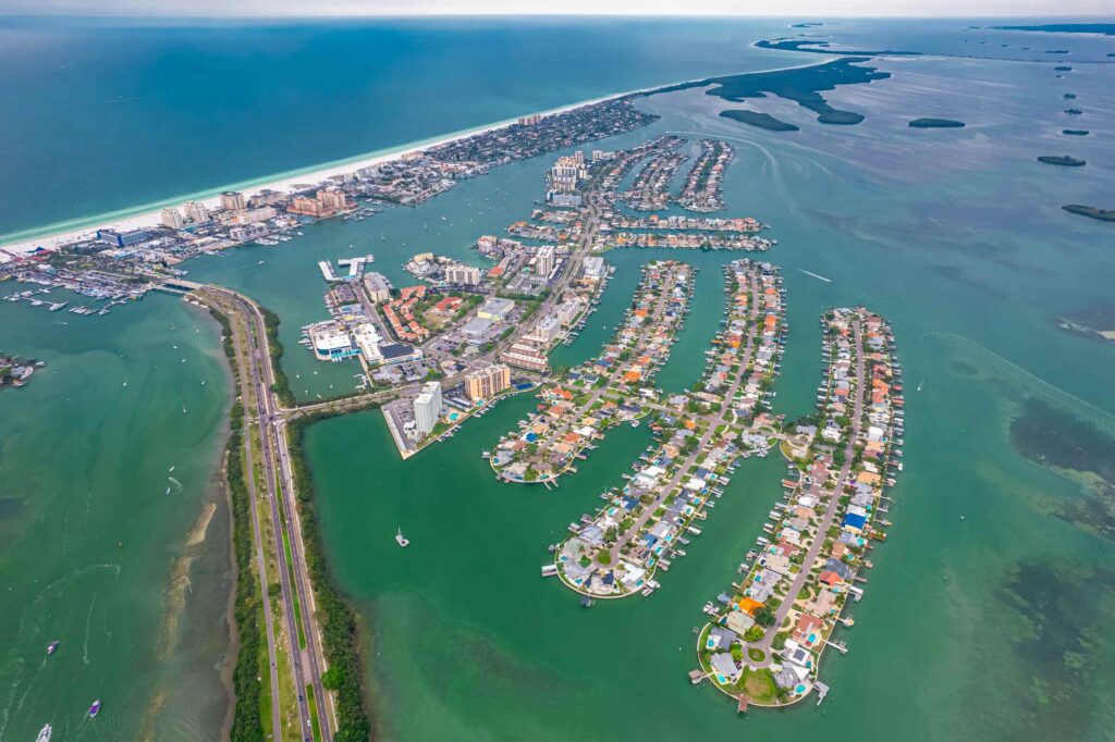 Aerial view of coastal Florida residential islands surrounded by clear green water.