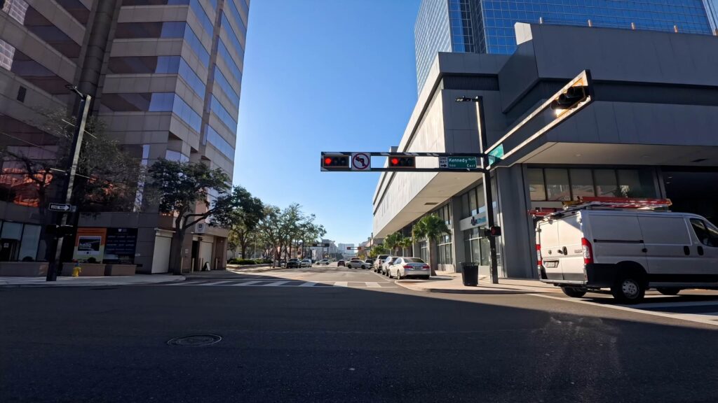 Downtown Tampa street intersection with traffic lights and high rise buildings.